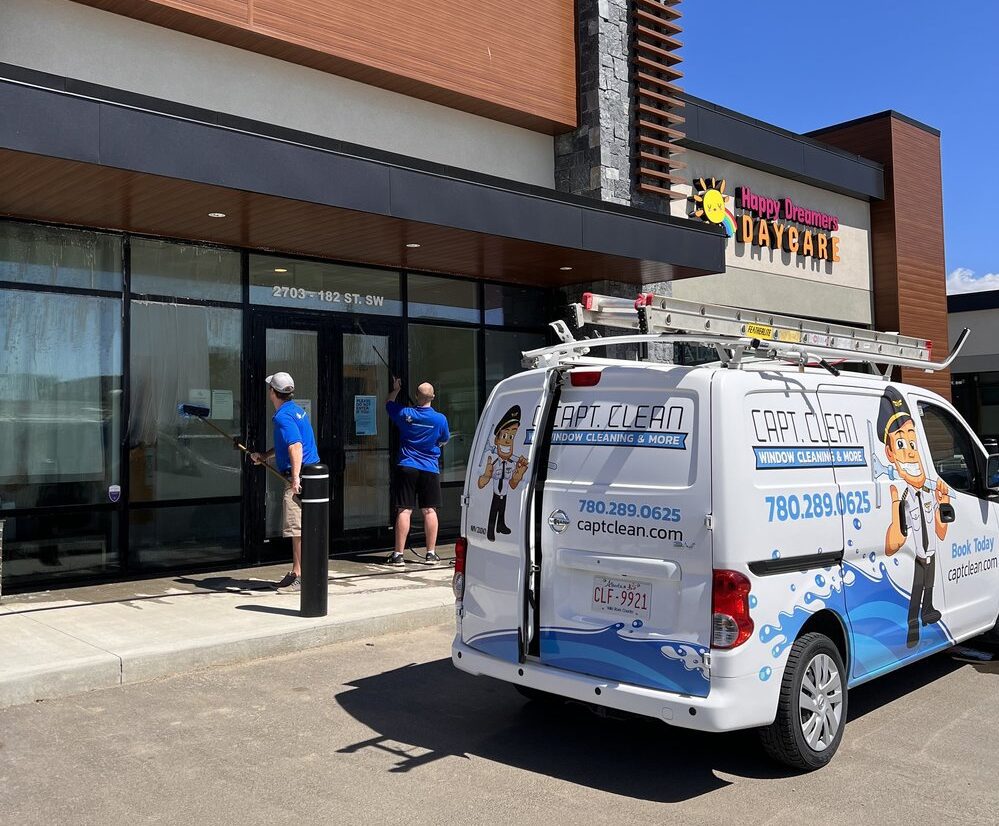Capt Clean van outside Edmonton business with workers washing windows.